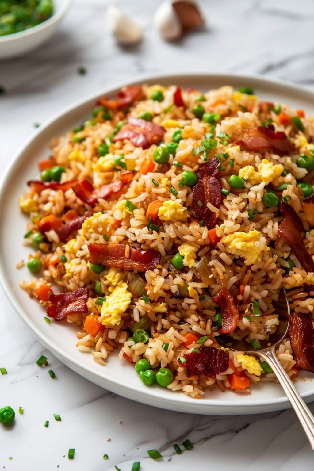 This bacon fried rice recipe swaps in crispy bacon and bacon fat for the sauté, making a 30-minute dinner that beats takeout and pork fried rice both.
